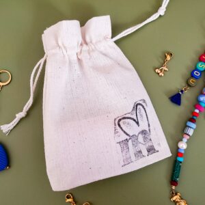 Pochette surprise en tissu contenant un accessoire coloré issu des collections précédentes