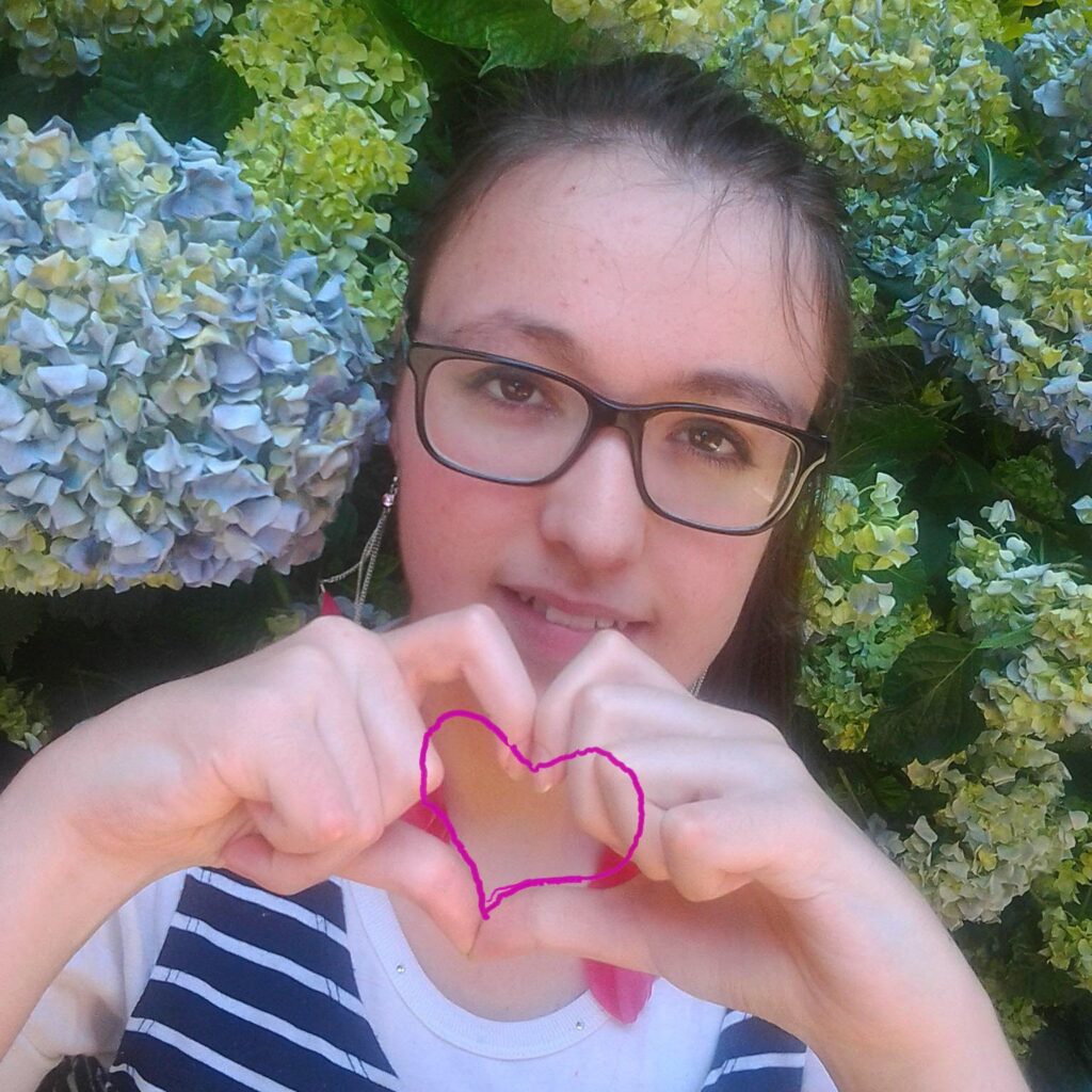 créatrice de bijoux colorés faits main portrait dans un jardin fleuri